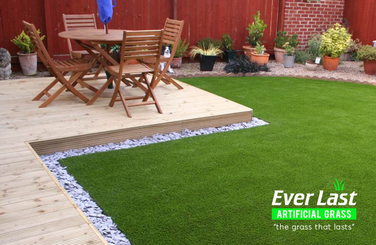 Patio and a set of wooden table and chairs on artificial grass